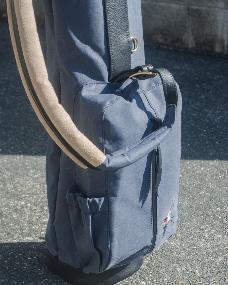 The Daybreak Sunday bag in blue-grey canvas with a tan strap