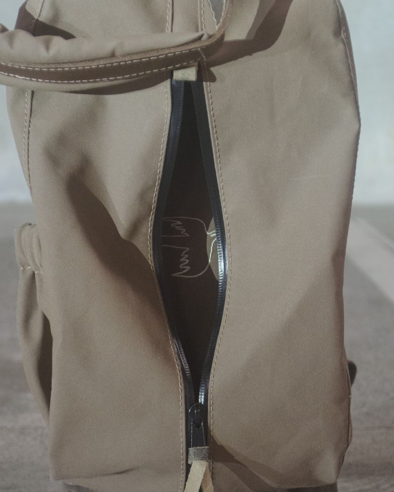 The zip pocket on a canvas Sunday bag