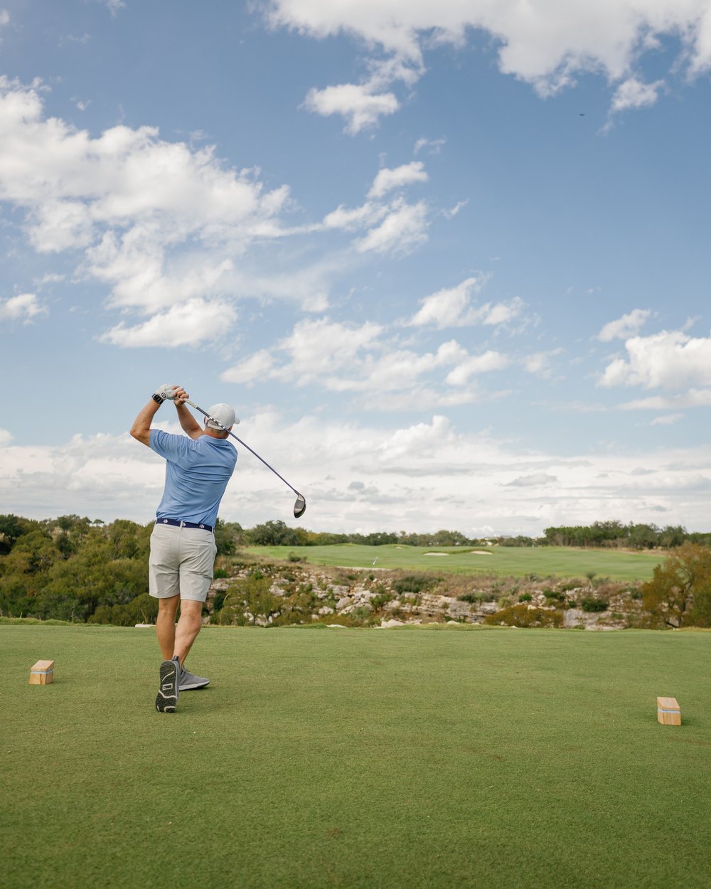 A golfer hitting a tee shot at Loraloma's opening event