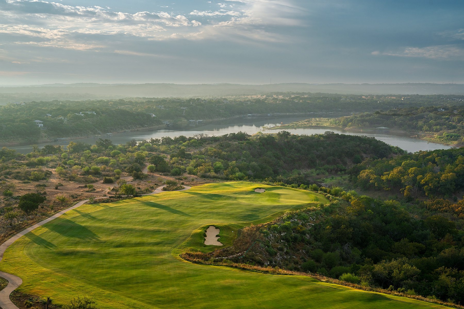 Aerial view of Loraloma's 18th fairway in morning light with the river in the distance