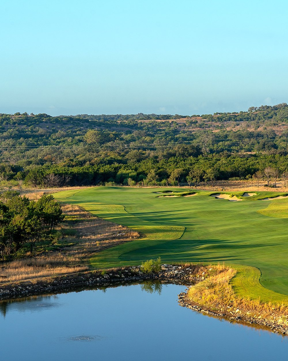 A Loraloma fairway running past a pond at sunrise