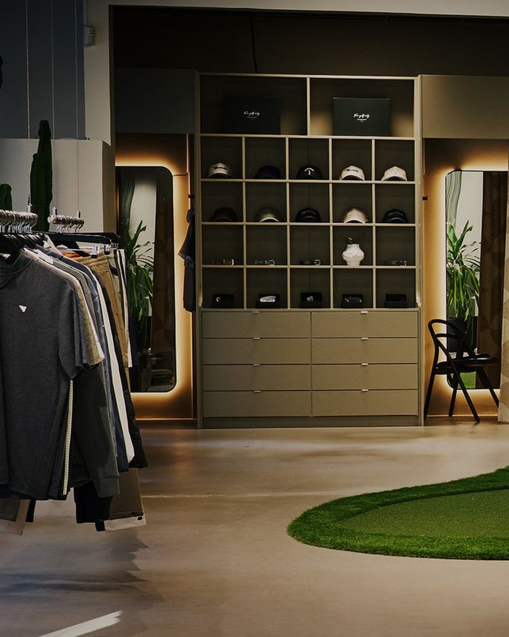 The Macade Clubhouse in Stockholm with a putting green, racks of clothes and a shop wall