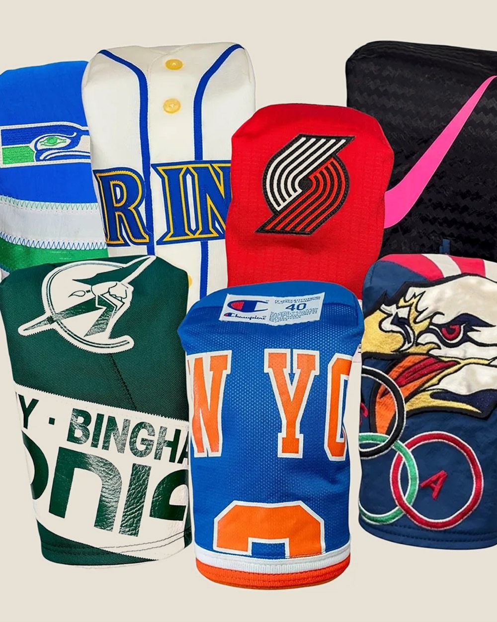 A pile of Matchstick headcovers sewn from sports jerseys, including New York and Seattle colors