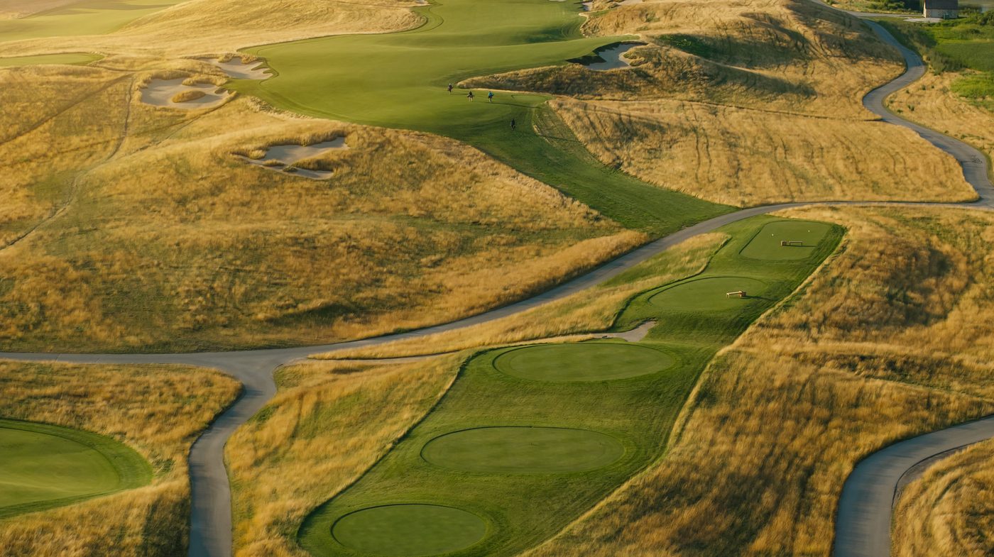 Aerial of tees, fairways and paths across rolling glacial terrain