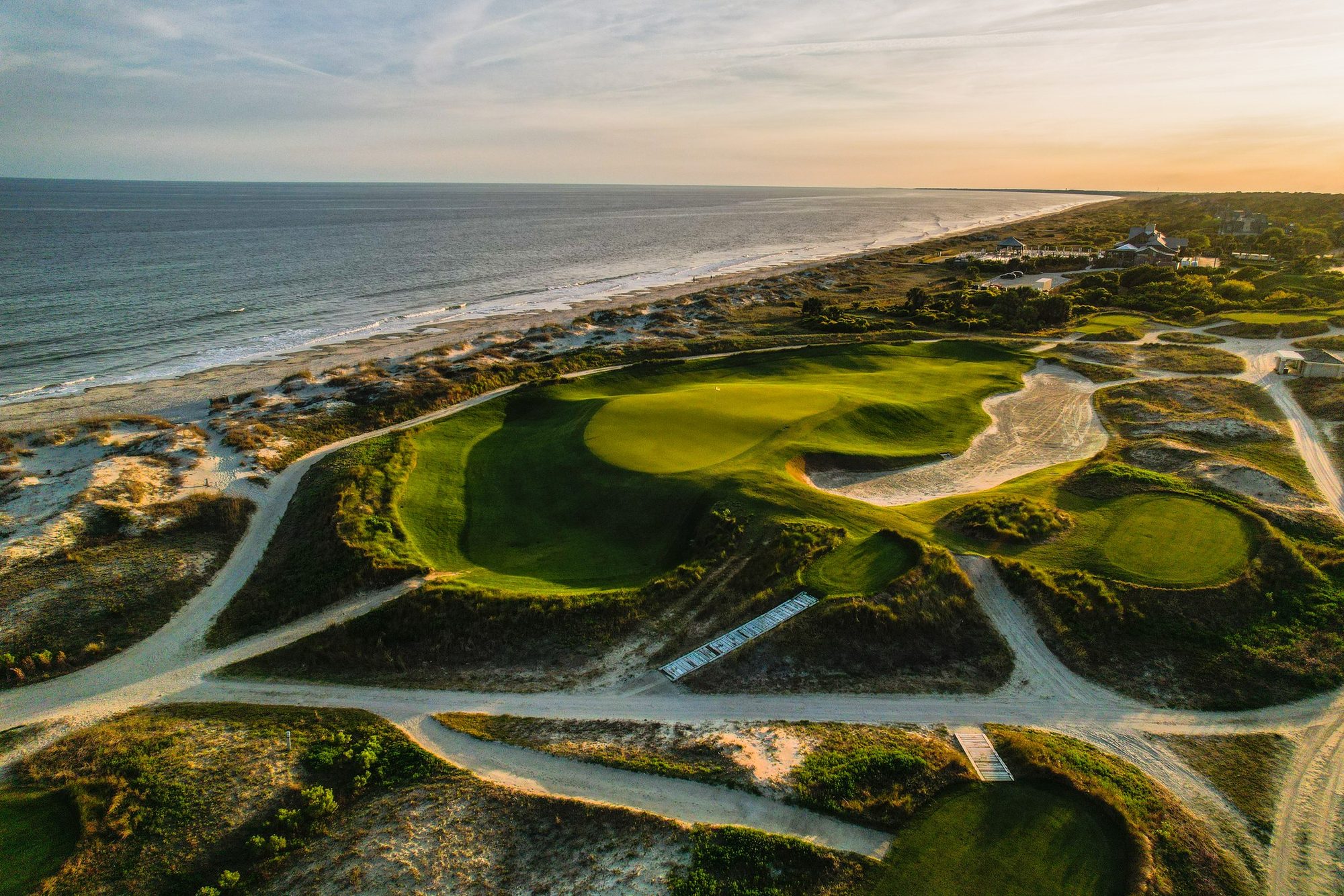 Aerial of Kiawah Ocean Course's 14th green in sandy dunes right above the Atlantic beach