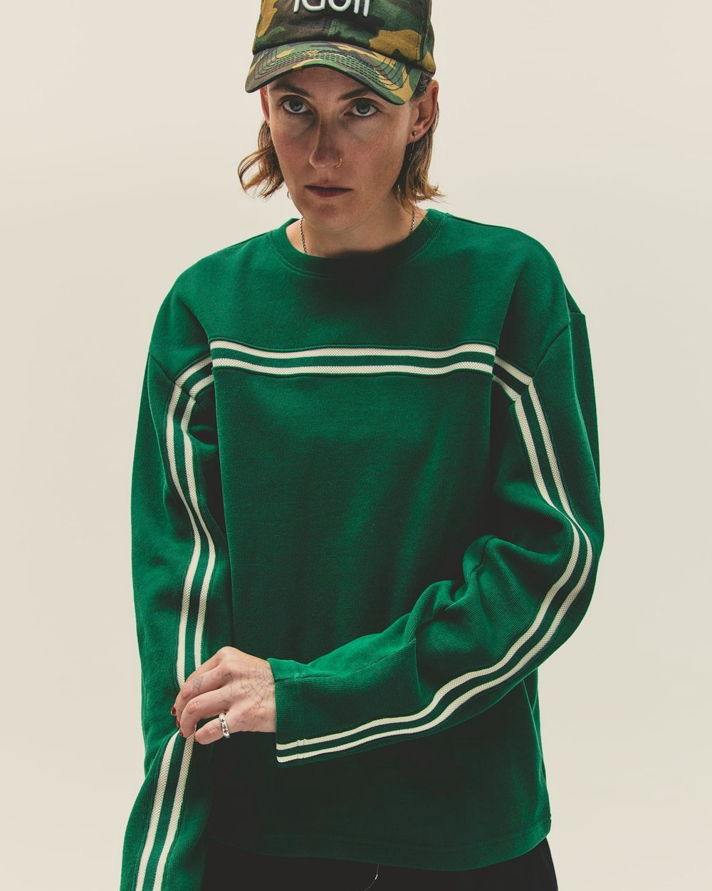 A woman in the green Surf Top and a camo iGolf hat