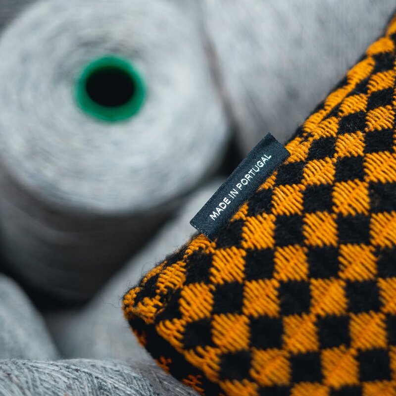 Checkered Mogshade headcover with wool spools in the workshop — @mogshade_golf