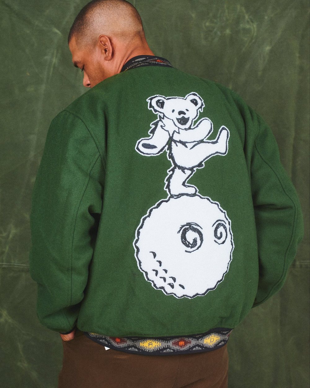 The back of the Malbon x Grateful Dead Long Vacation varsity jacket