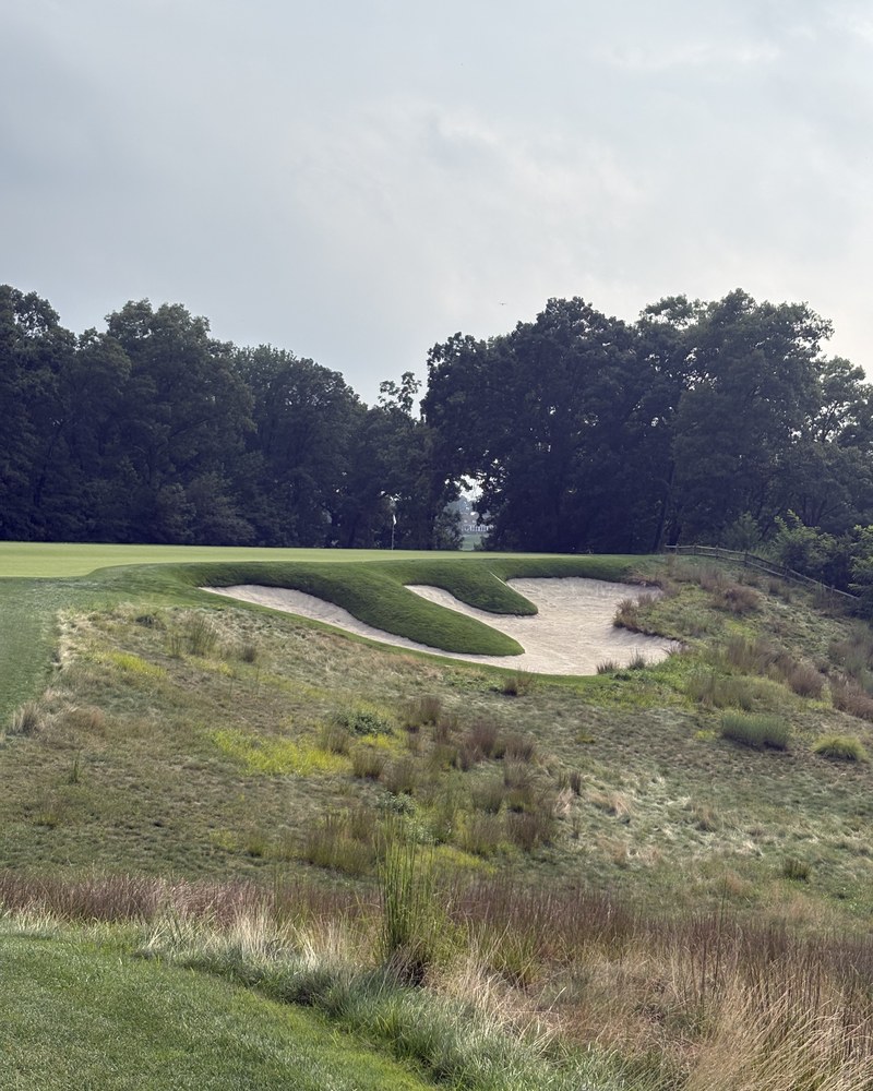 A deep sand bunker set into native grasses on the Bethpage Black Course