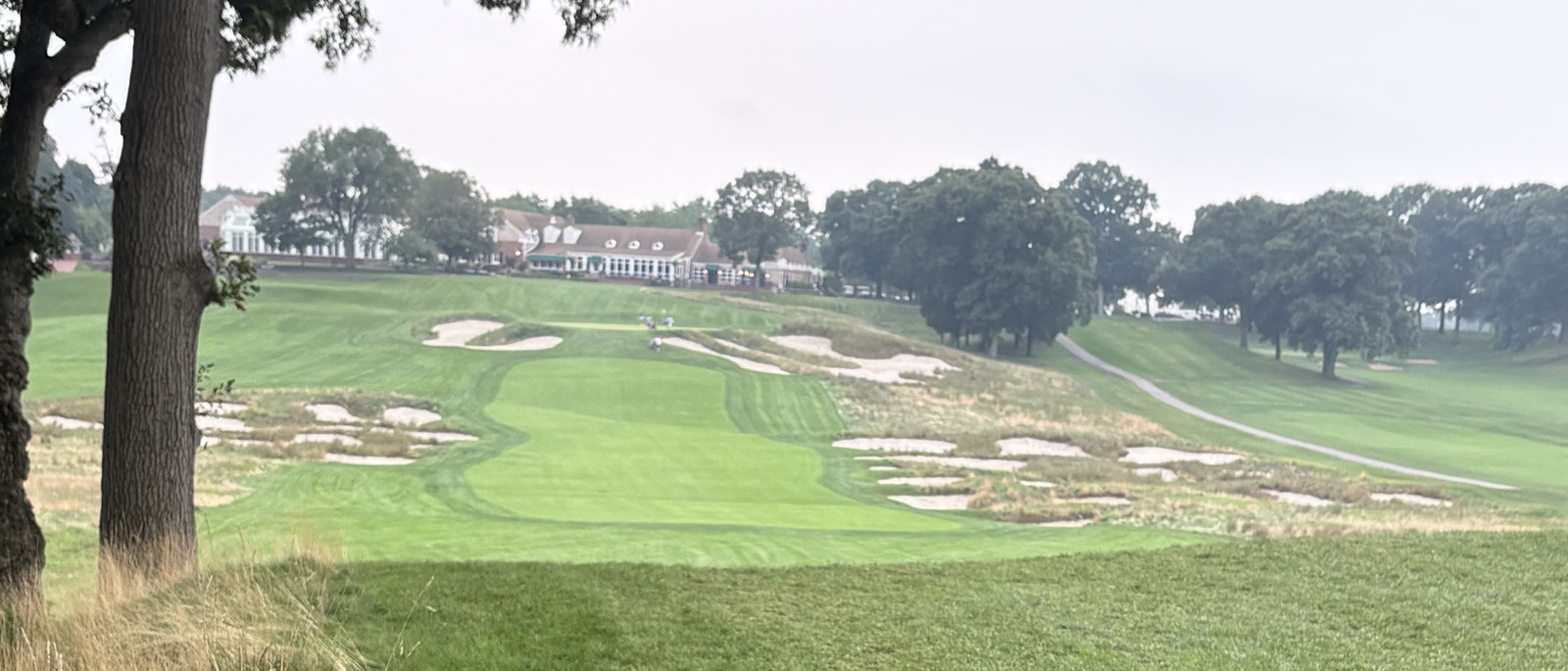 The Bethpage clubhouse across a bunkered hole on the Black Course