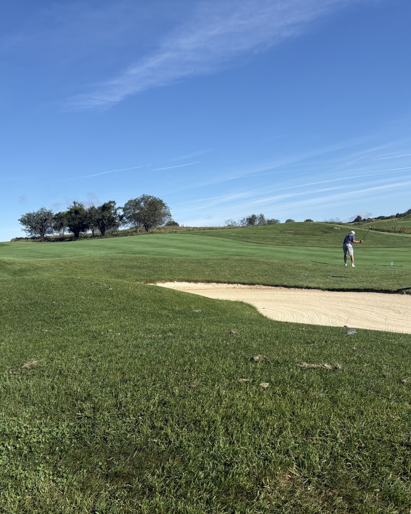 A bunker cut into fescue under open sky at The Links at Union Vale