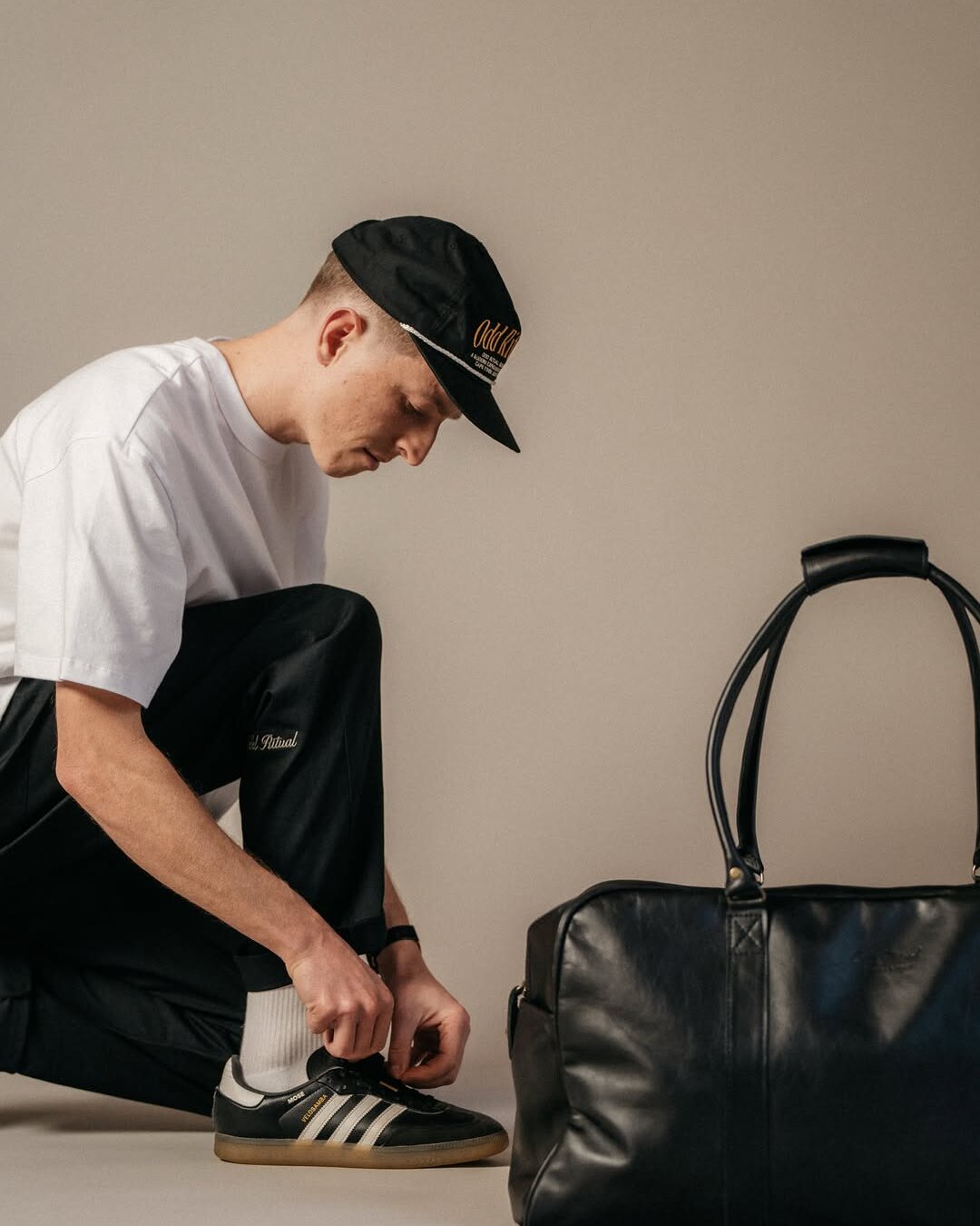 Odd Ritual on Instagram — studio still with leather bag and Sambas