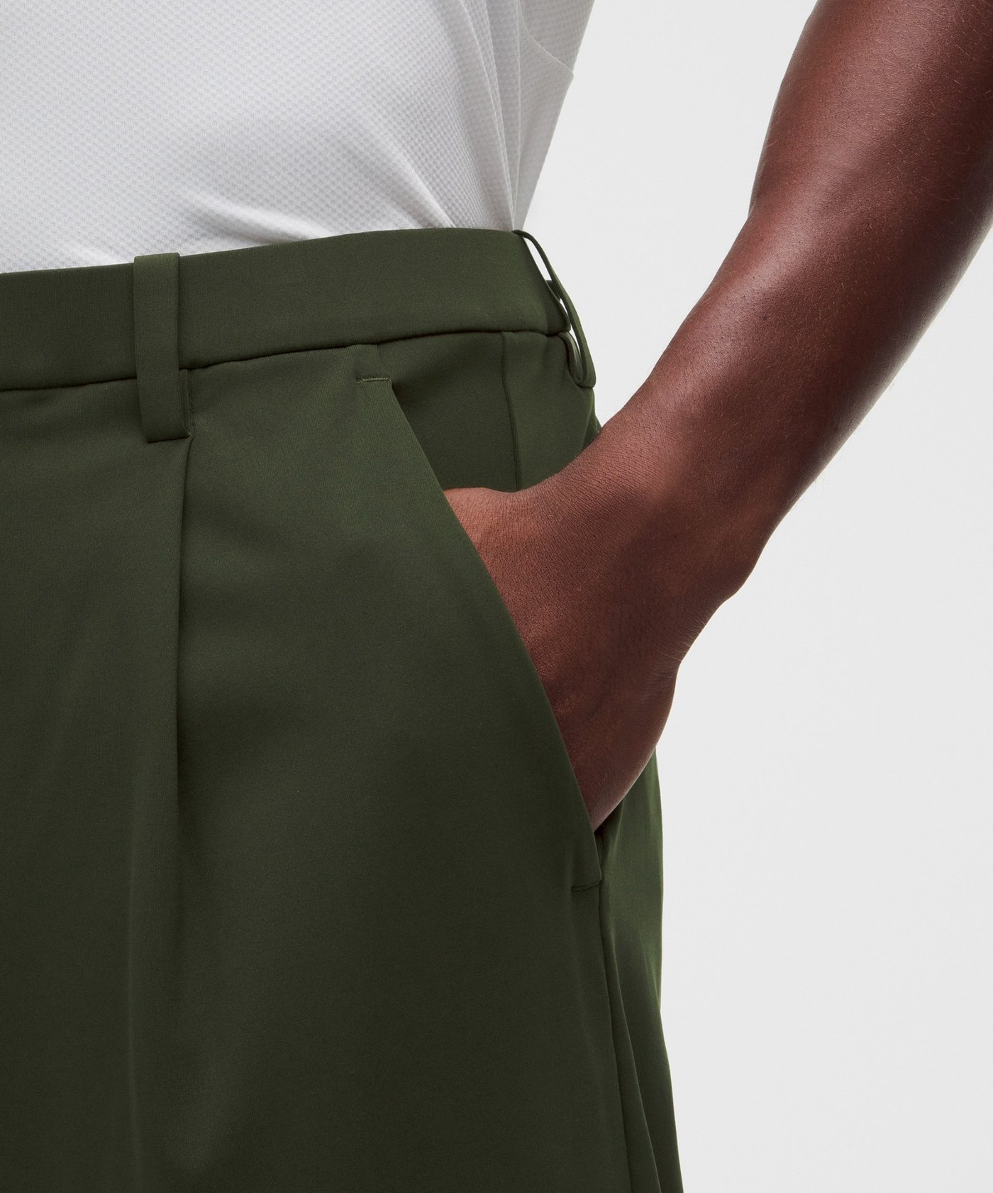 A hand in the pocket of Deep Forest lululemon Daydrift pleated trousers