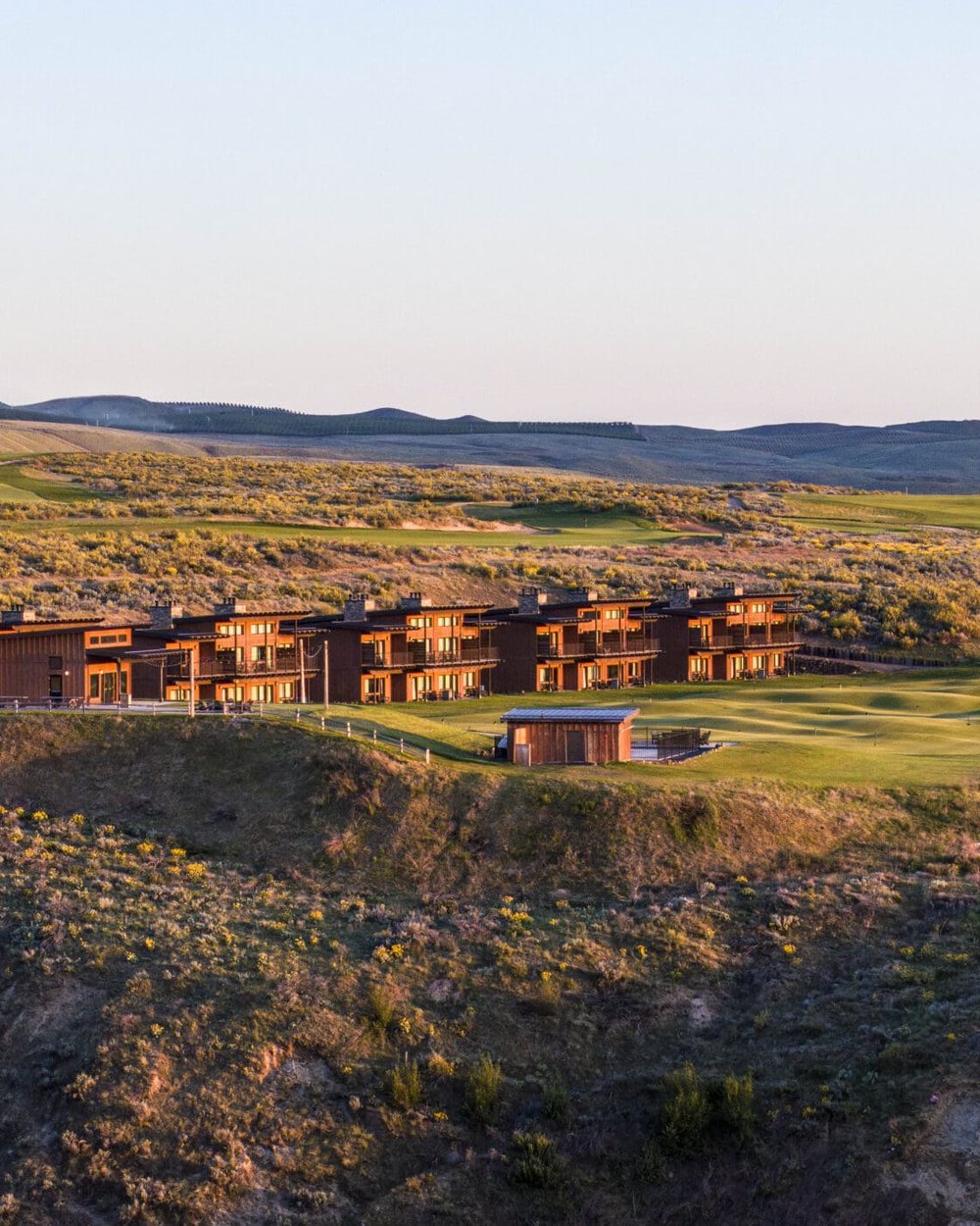 The Inn at Gamble Sands on the bluff with the Cascades behind