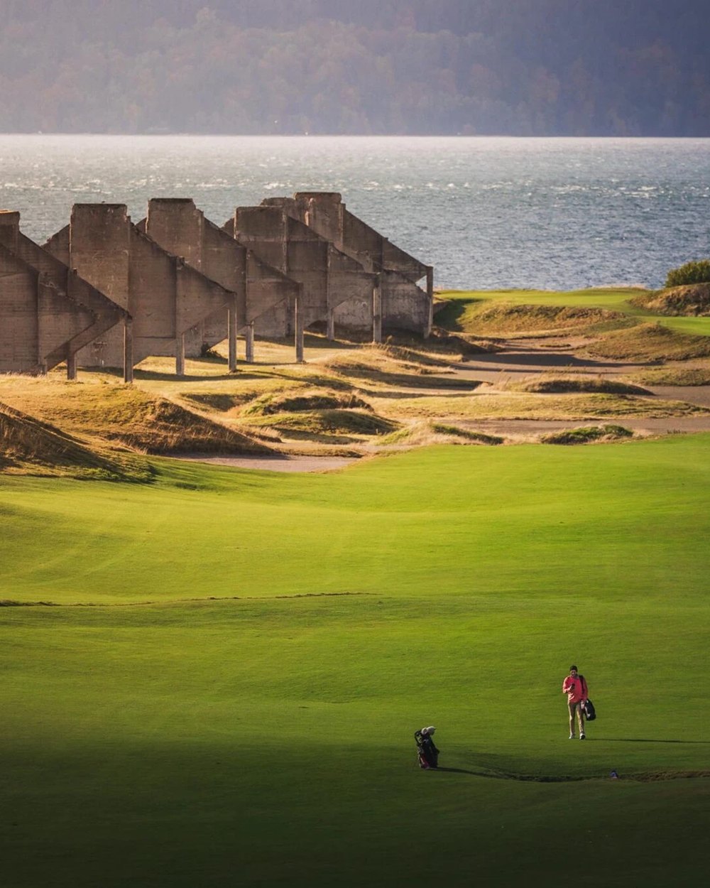 The Chambers Bay clubhouse above a green with Puget Sound behind