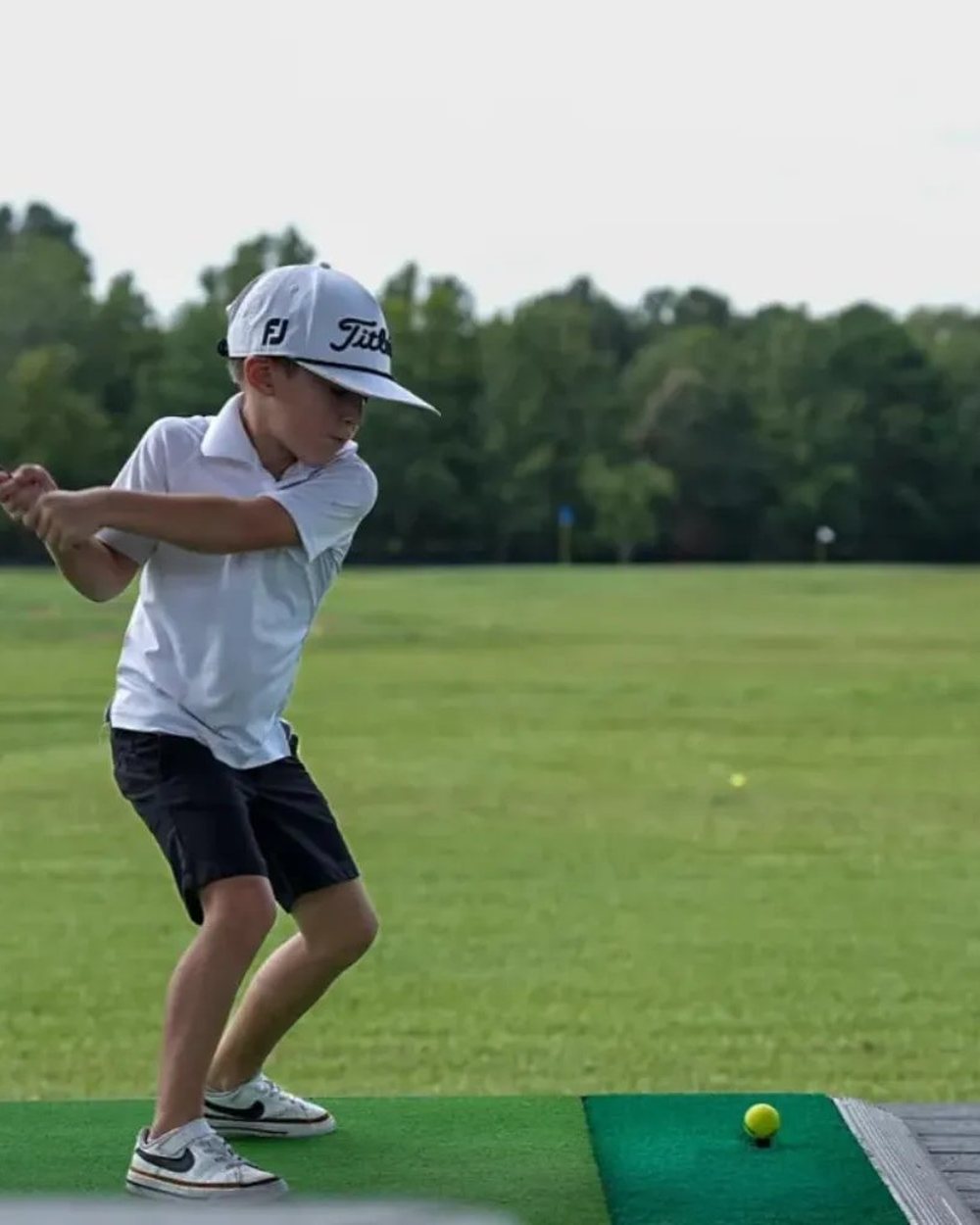 A junior golfer hitting from a Power Tee at Teravista