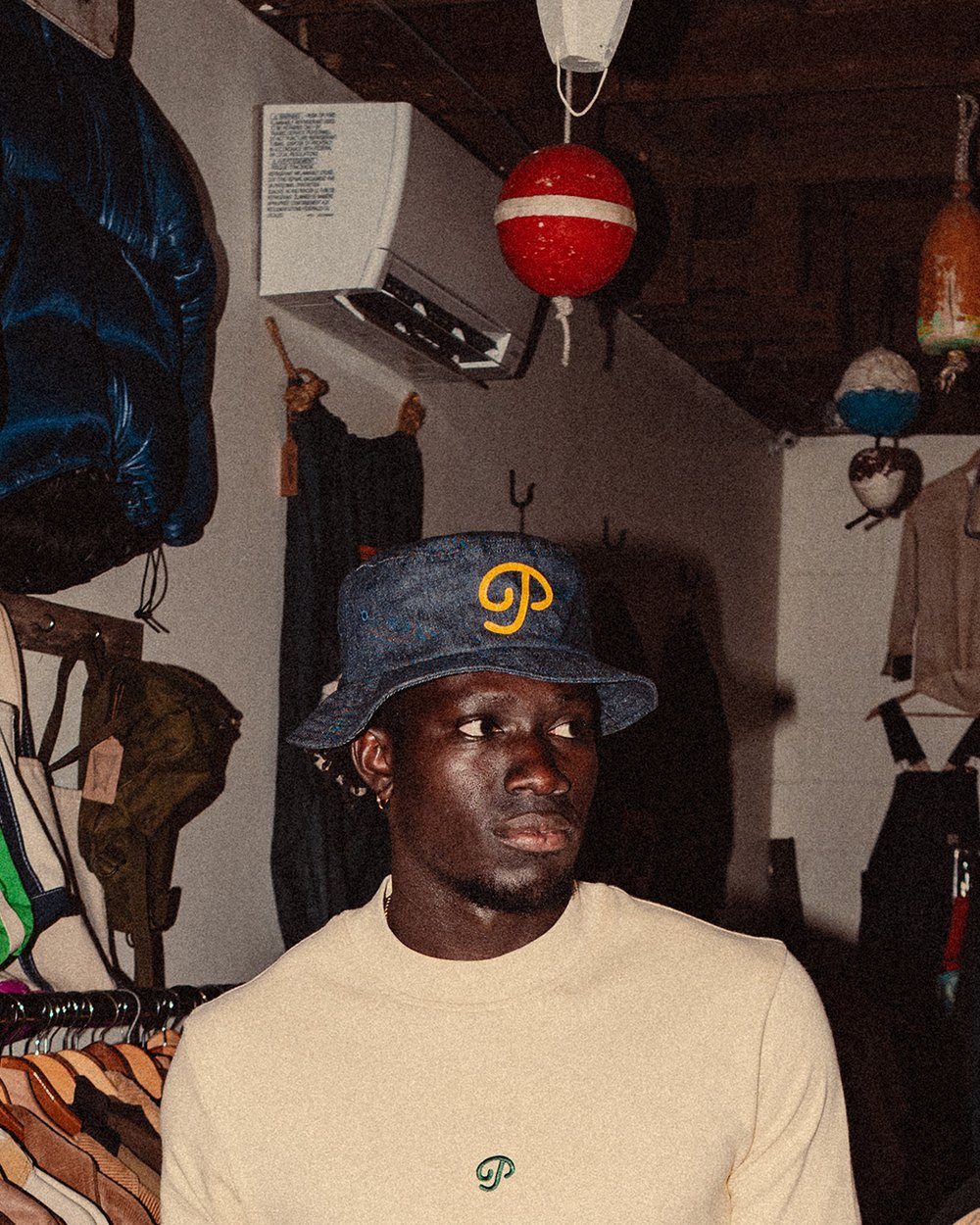A man in the denim P script bucket in a vintage clothing shop