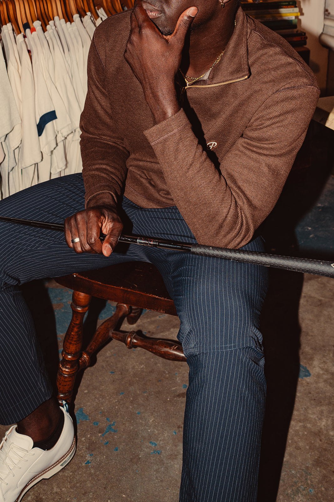 Close-up of a coffee knit and a golf club in a vintage shop
