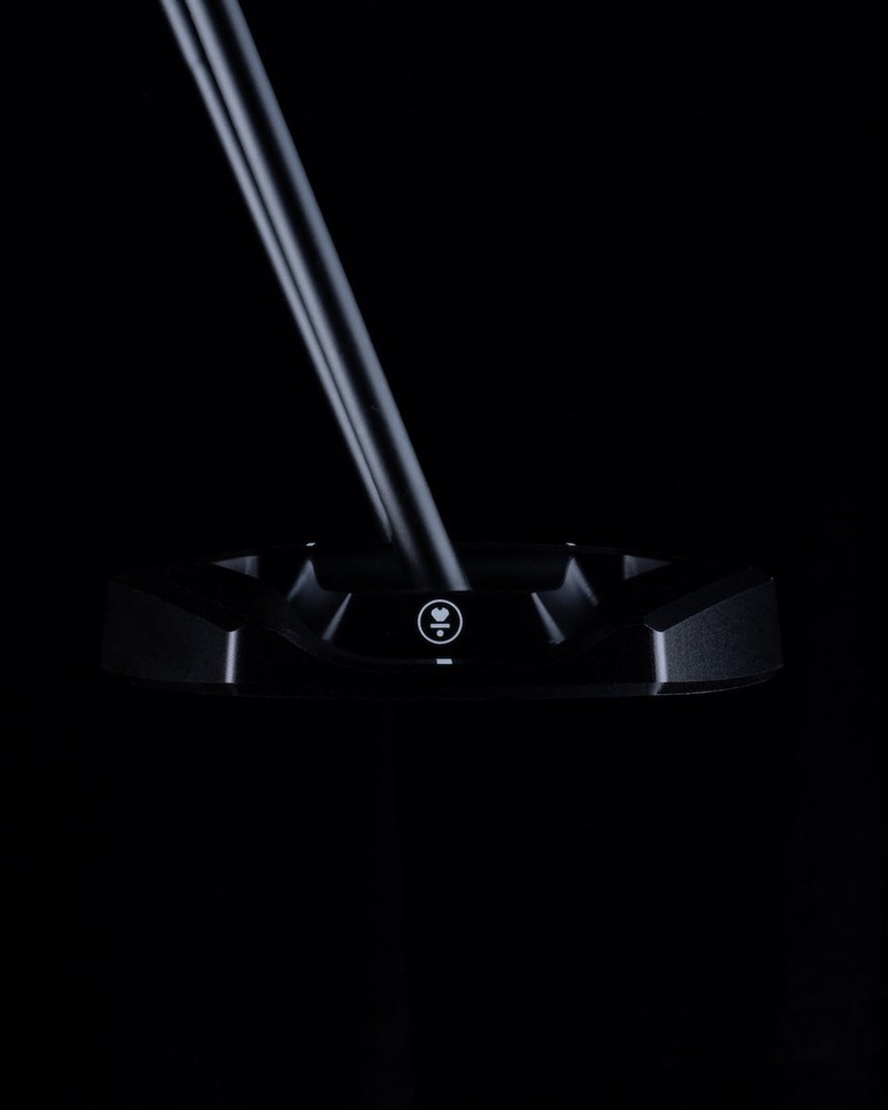 The L.A.B. Golf VZN.1i putter head lit against a black studio backdrop