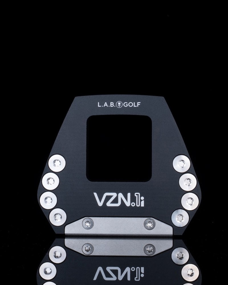 The sole of the L.A.B. Golf VZN.1i putter showing the adjustable weight ports