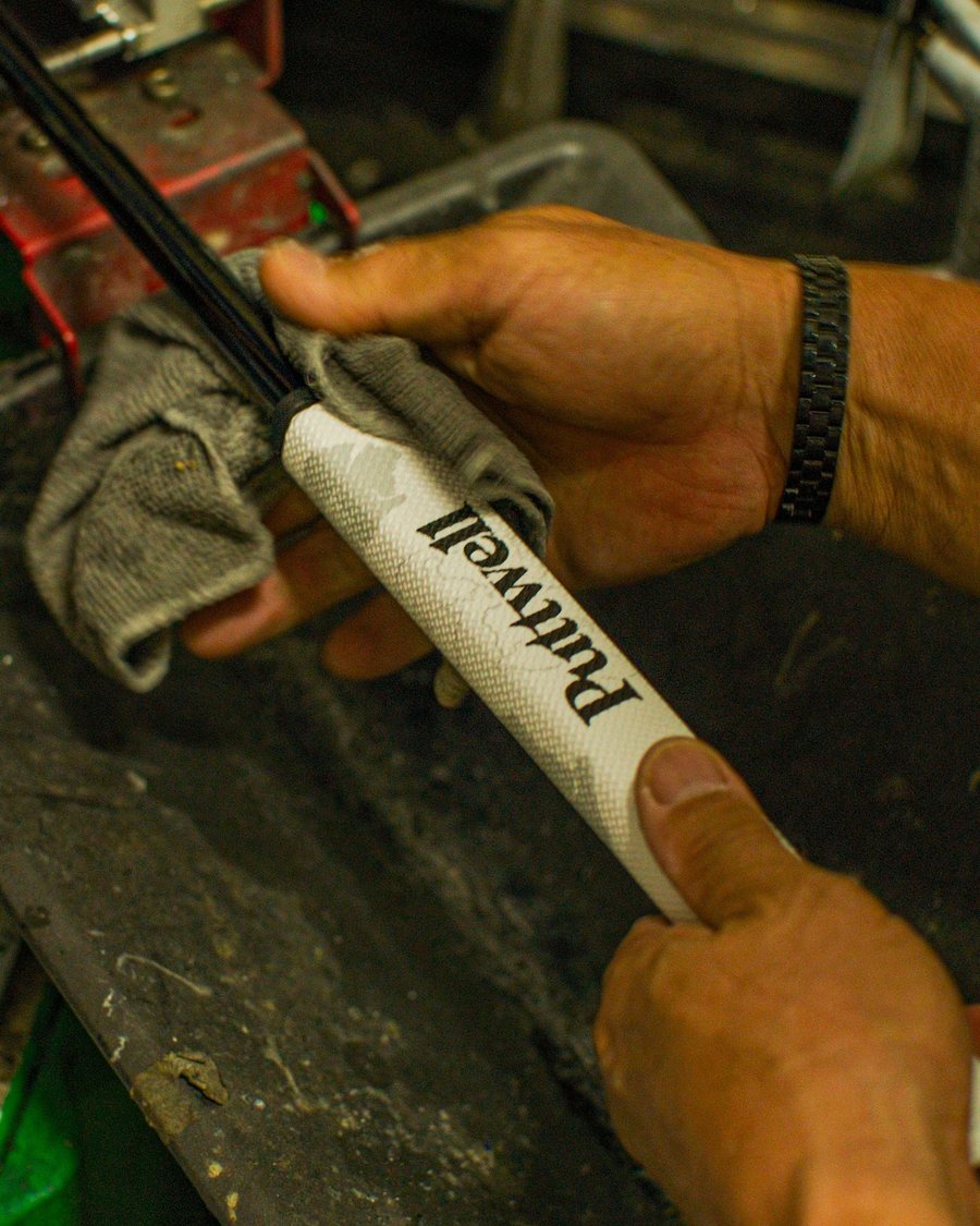 Hands gripping a Puttwell putter