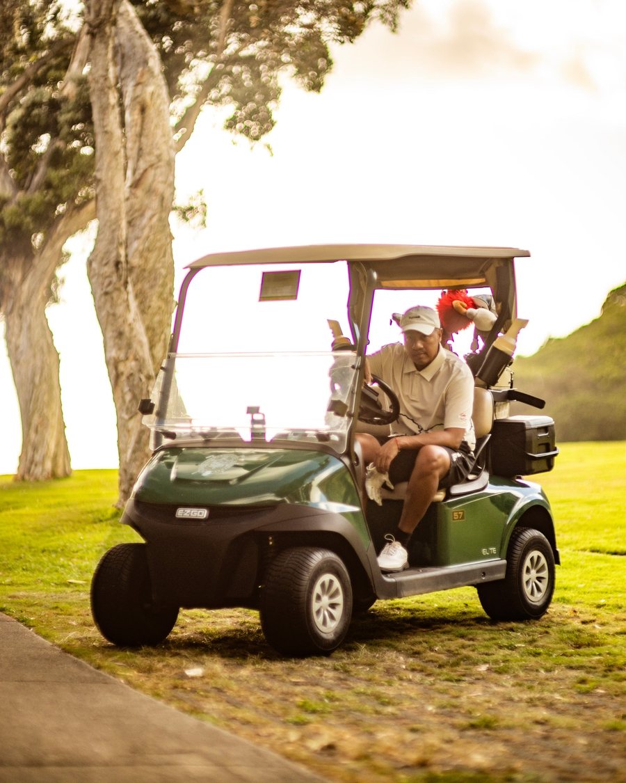 Puttwell golfers in a cart under the trees