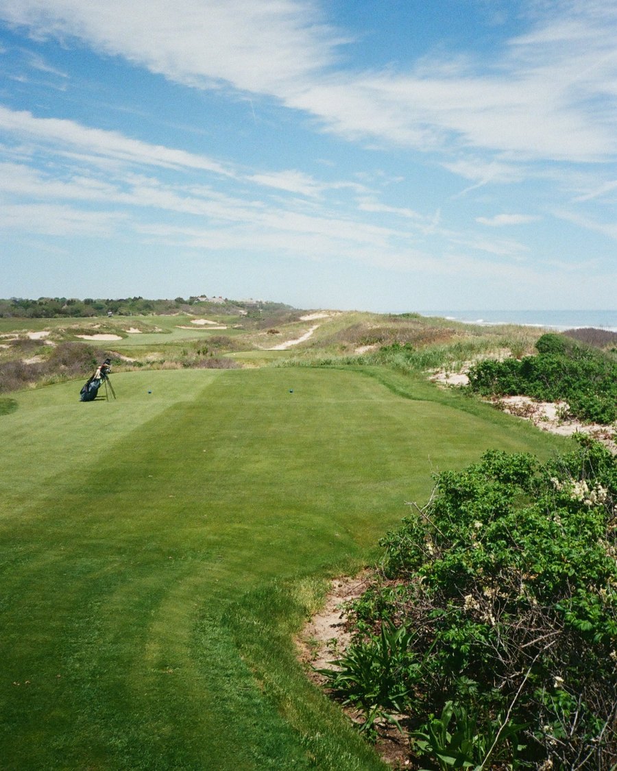 A fairway running between dunes toward the sea