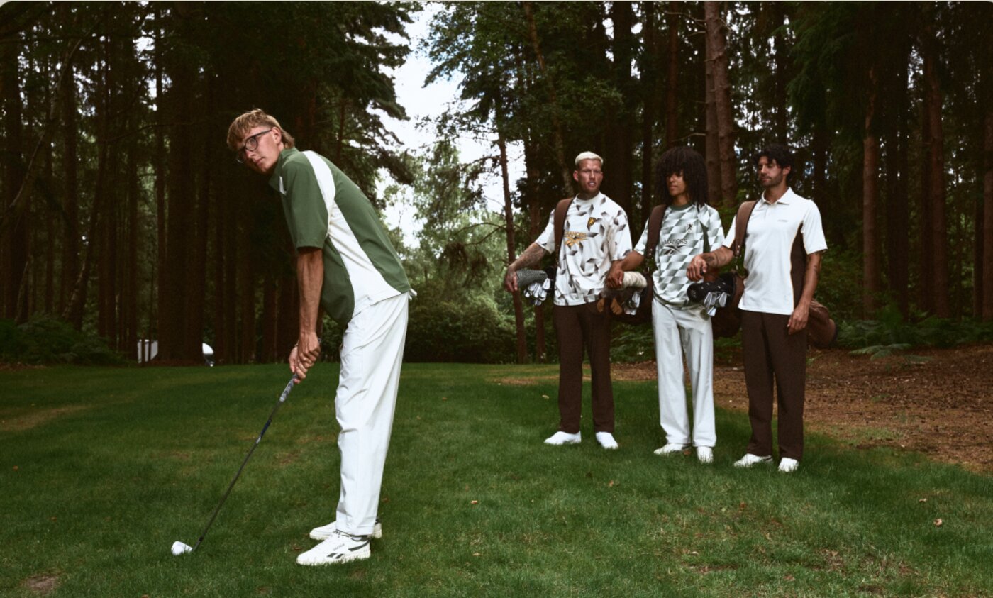Reebok x Manors II campaign — four golfers in the collection on a tree-lined course