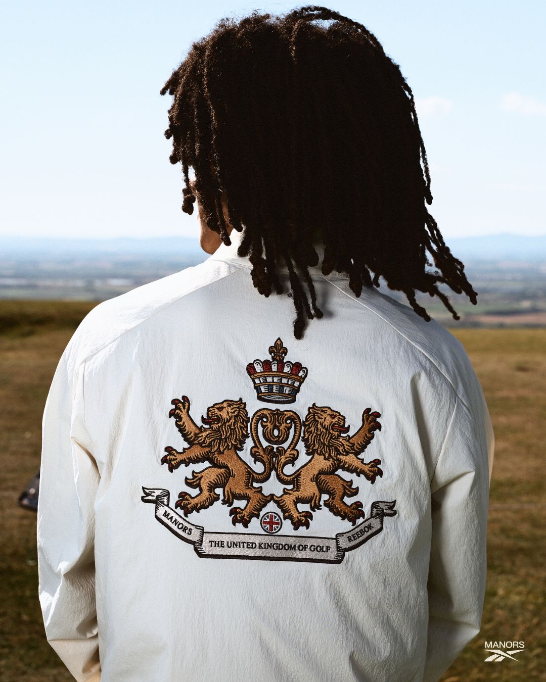 Reebok x Manors II Tour Shirt with The United Kingdom of Golf crest — lions, crown, and Union Jack embroidery
