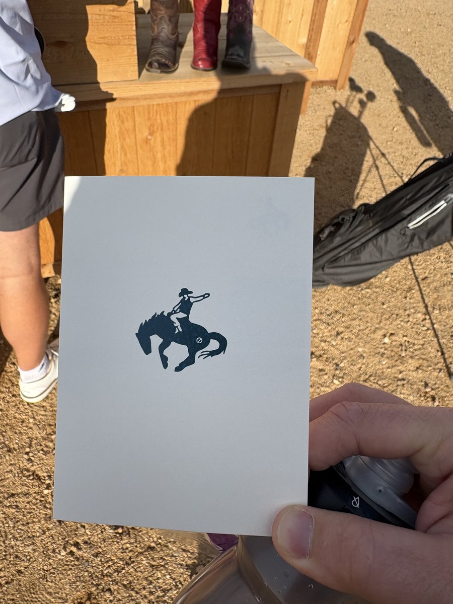 Rodeo Dunes scorecard featuring the bronco rider logo, cowboy boots visible in background