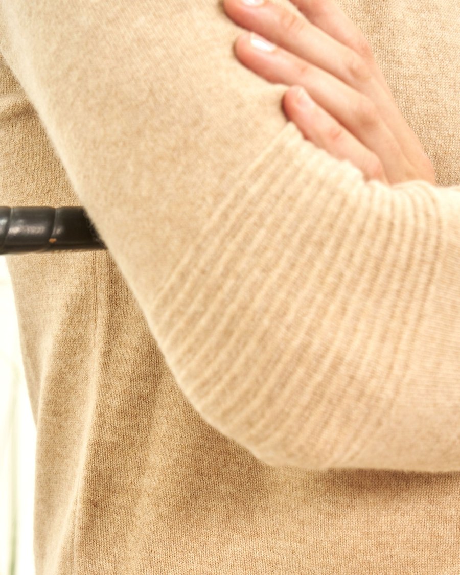 A cashmere sleeve folded over a golf club