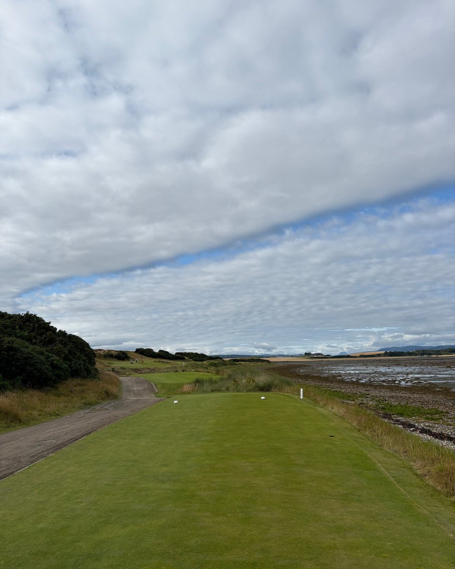 A links fairway under a long bank of cloud