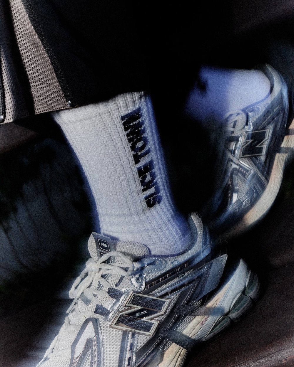 White SLICE TOWN socks with grey trainers, shot from above