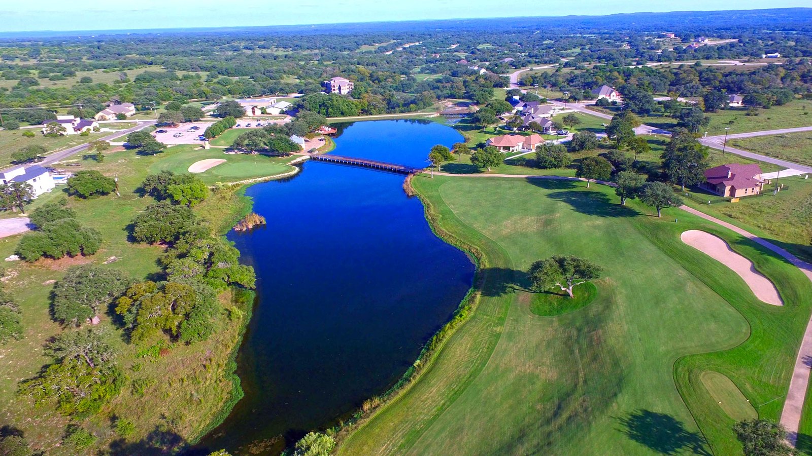 Vaaler Creek Golf Club from above, a fairway beside a long blue lake
