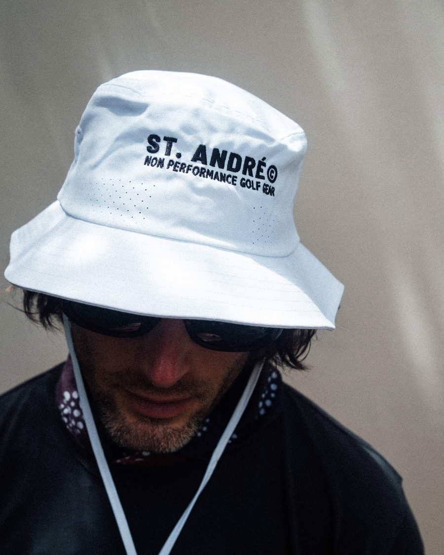 A man in a white St. André bucket hat