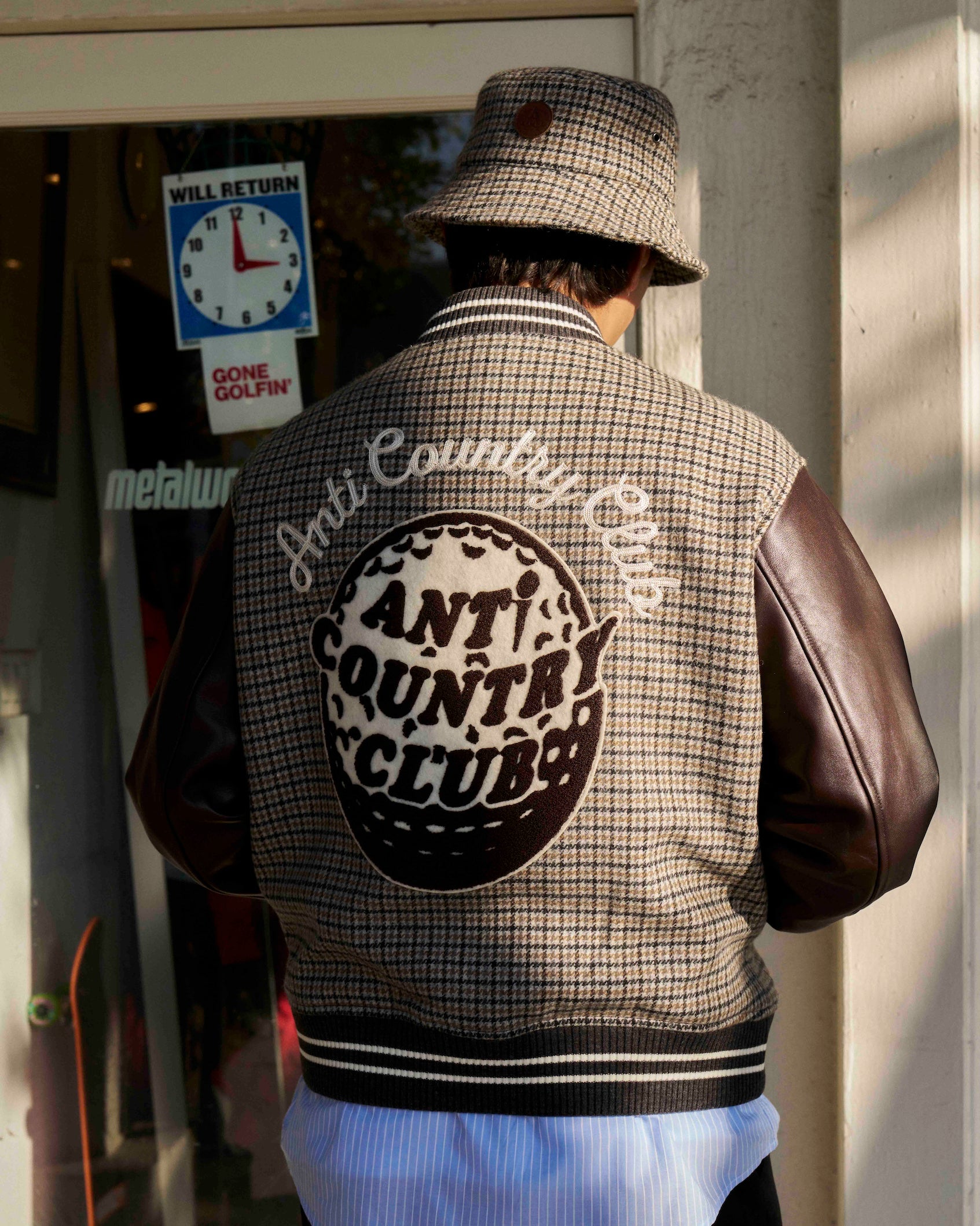 ANTi Country Club Tokyo varsity jacket in brown, club crest across the back