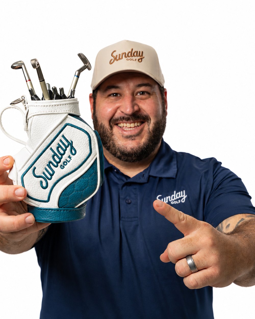 A smiling man in a Sunday Golf cap holding the mini staff-bag pen holder full of tiny clubs
