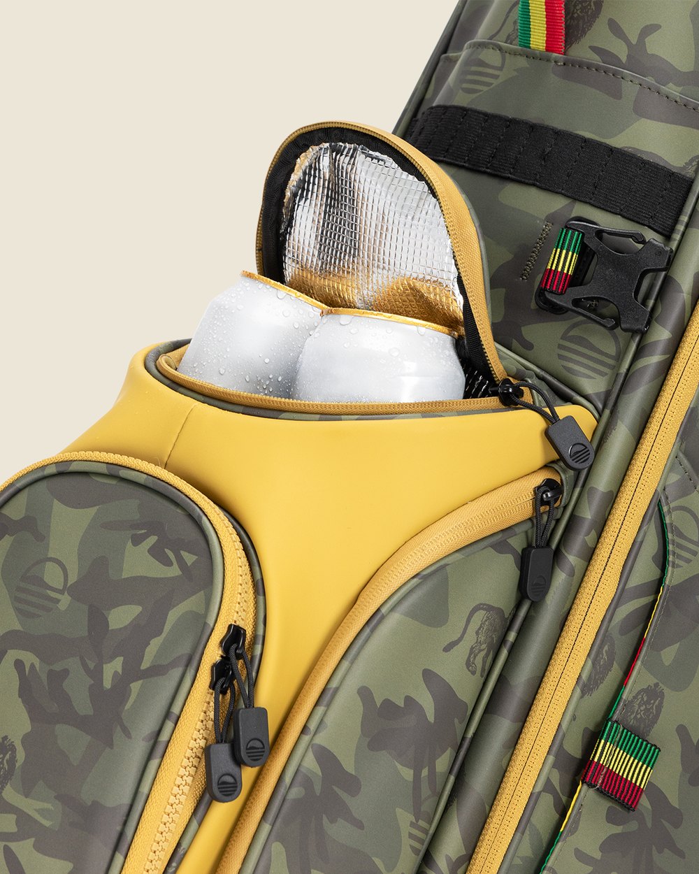 Two cans in the insulated Frosty pocket of a camo Sunday Golf bag with yellow trim