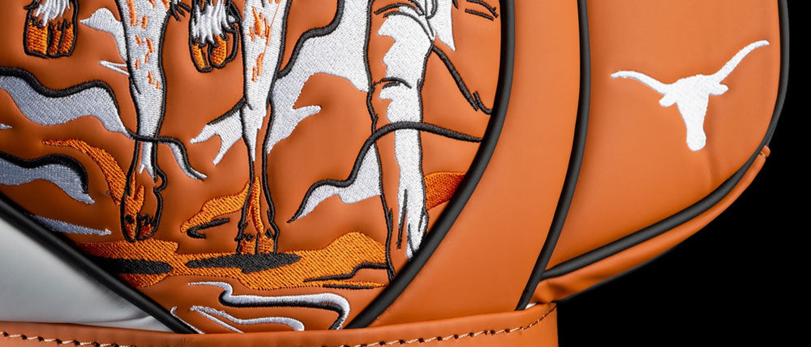 Detail of the Swag Golf Texas Longhorns Den Caddy cooler, TEXAS in white script below a longhorn-rider illustration in burnt orange