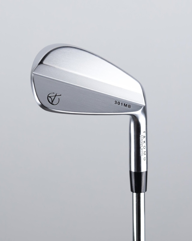 Takomo Iron 301 MB forged muscle back iron against a green background