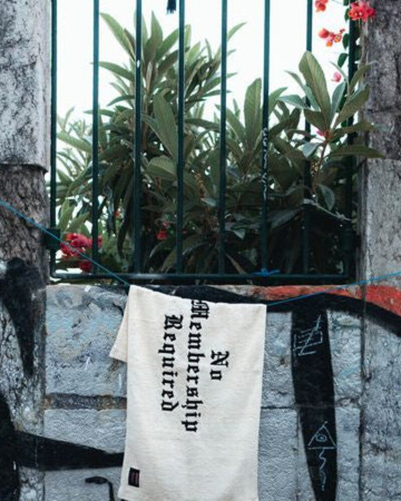 Mogshade x Parmore No Membership Required towel shot against a graffitied wall
