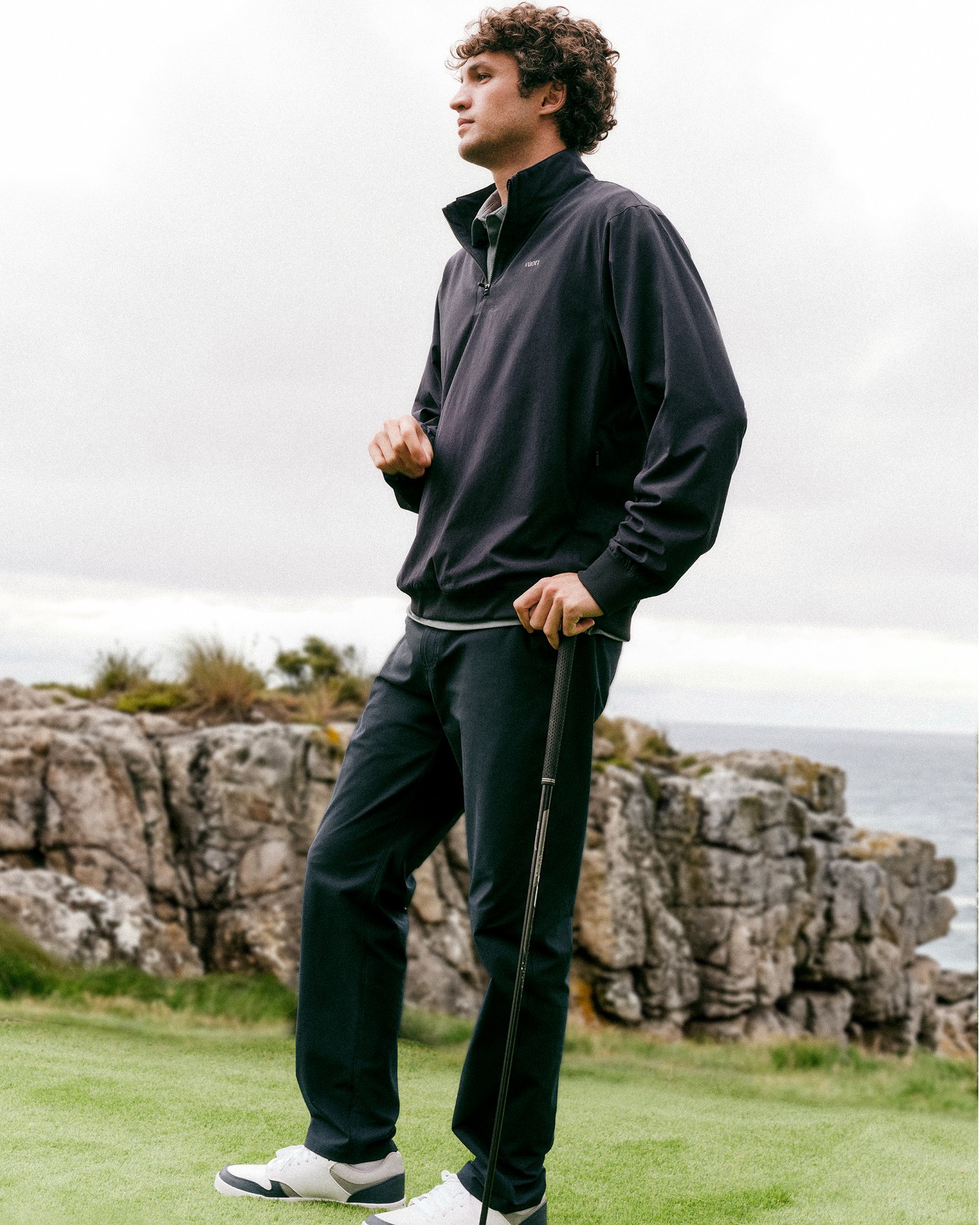 Vuori — the FA26 lookbook: quarter-zip and trousers on a clifftop course