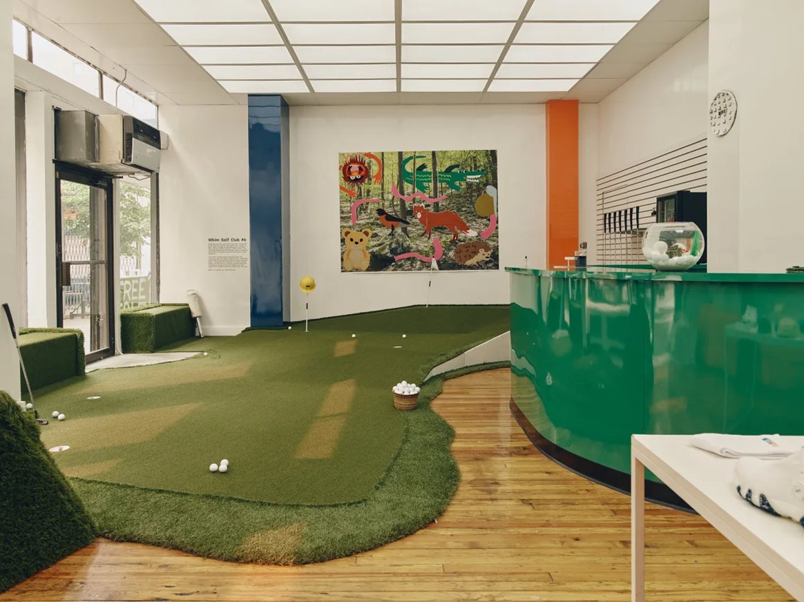 A green putting surface running through Whim's pop-up shop on Avenue A in New York