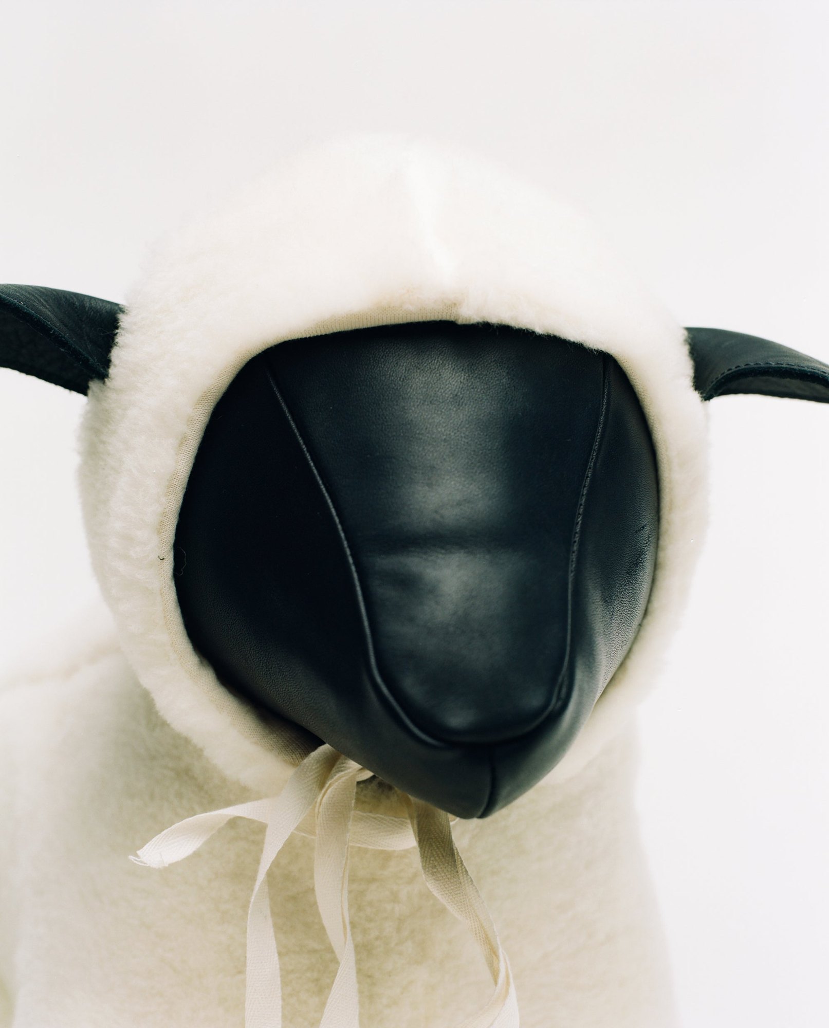 A handmade leather sheep wearing a merino coat
